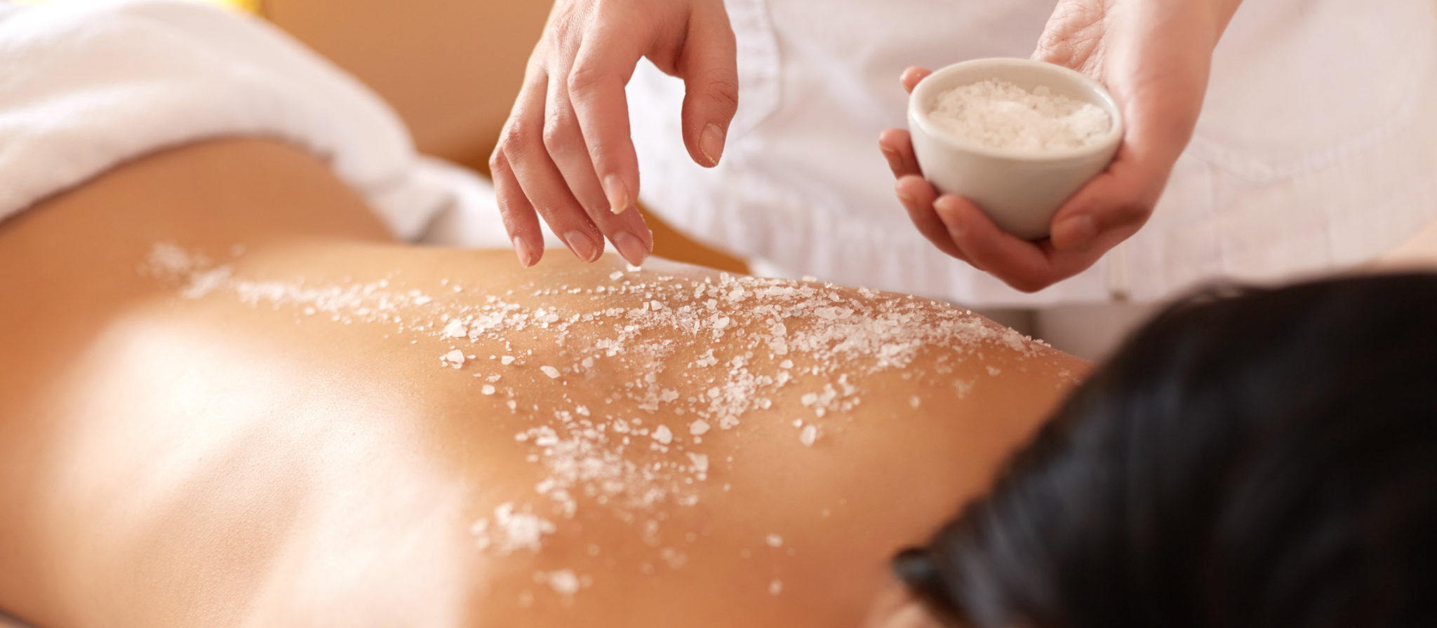 Spa,woman.,brunette,getting,a,salt,scrub,beauty,treatment,in