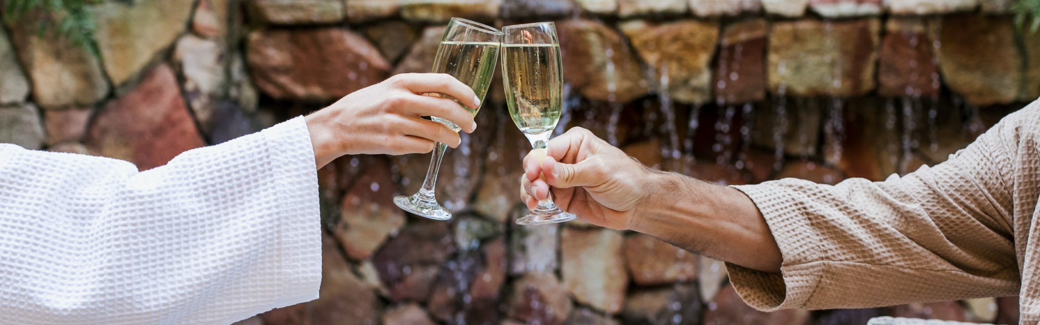 Woman and Man cheering with Champagne Glasses