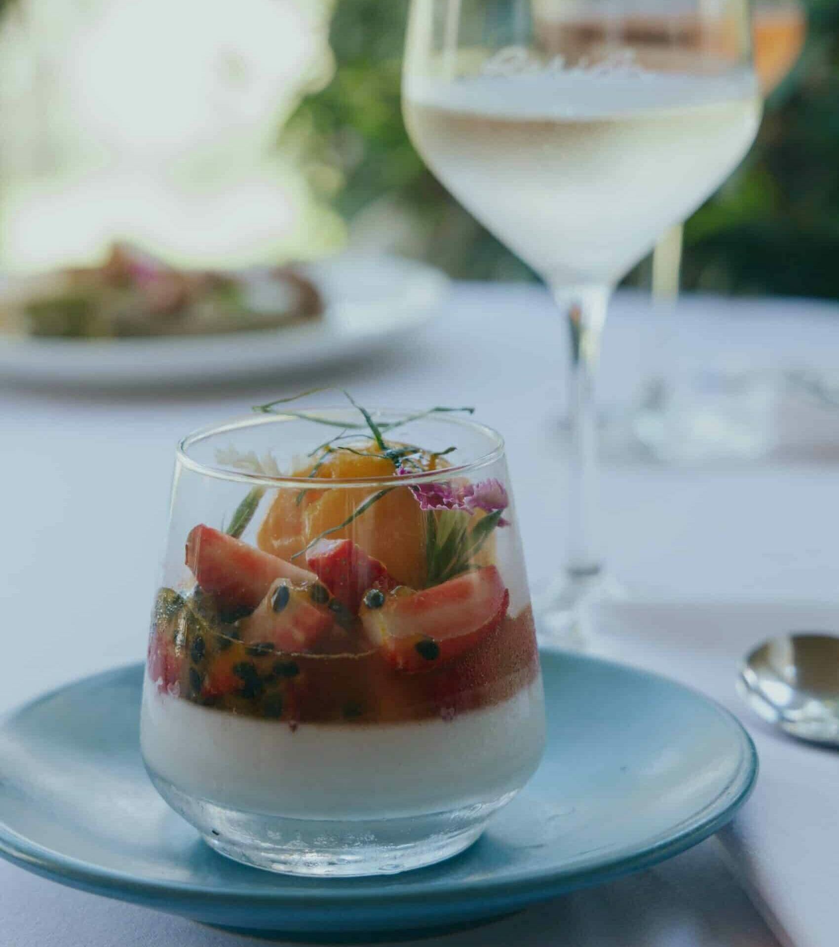 Noosa Springs New Spring Menu September 2024. Kaffir lime and coconut panna cotta with strawberries, mango sorbet and passionfruit (gf/vegan)